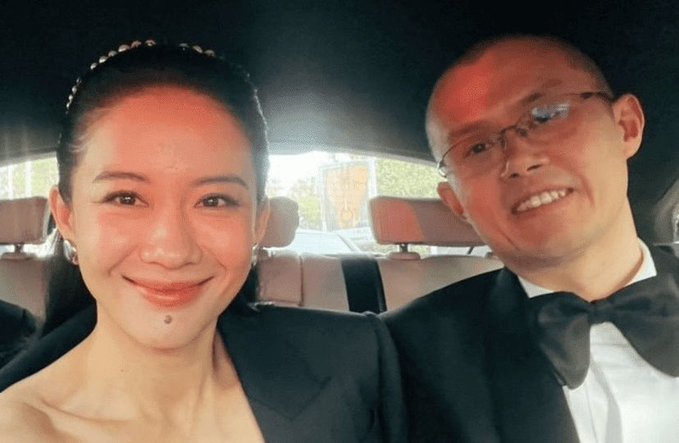 A selfie of a smiling woman wearing a pearl-studded headband and a man in a bow tie and glasses, taken inside a car. The image likely accompanies the user's heartfelt testimony about their five-year journey with Binance and continued loyalty to BSC across various crypto sectors.