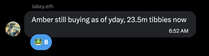 A screenshot of an iMessage conversation from 'Jakey.eth' at 6:52 AM stating 'Amber still buying as of yday, 23.5m tibbies now' with a frog emoji reaction with 8 likes.