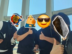 Three people wearing matching dark blue shirts pose for a selfie, with two of their faces obscured by cartoon stickers (a peanut character and a sunglasses-wearing emoji), while giving thumbs-up gestures.