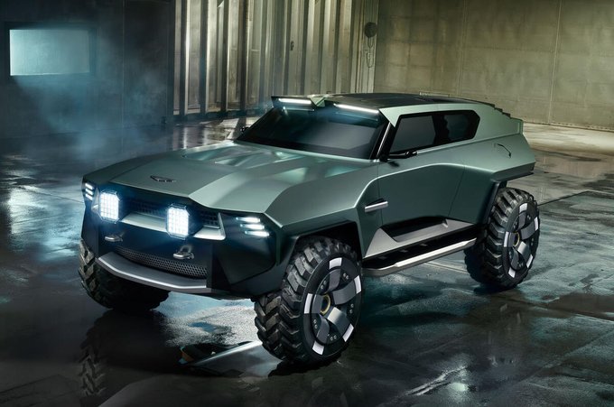 Futuristic matte green armored SUV concept vehicle parked in an industrial warehouse setting.