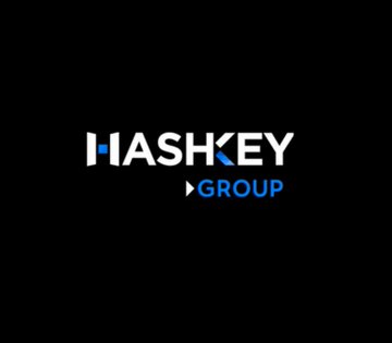The image displays the HashKey Group logo on a black background, featuring white text "HASHKEY" with a blue triangle accent above the "K," and "GROUP" written below in blue with a small blue triangle.

The logo represents HashKey, the Asian crypto firm partnering with Franklin Templeton to bring tokenized U.S. government funds to Asian investors.