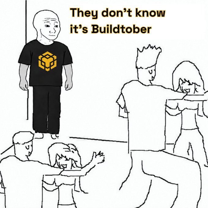 A "wojak" meme shows a stoic bald figure in a Buildtober-branded t-shirt standing apart from excited cartoon couples socializing, captioned "They don't know it's Buildtober" — humorously portraying the annual drawing/art challenge as a lone creator diligently working while others remain oblivious.