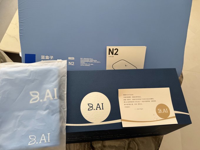 A photo of 8.AI brand products, including a light blue drawstring bag, a dark blue box with '8.AI' and a moon logo, a card with Chinese text, and a small booklet labeled 'N2'.