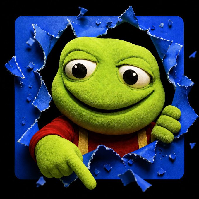 A green plush frog puppet with large eyes and a red shirt bursts through a torn blue paper background, pointing its finger outward.
