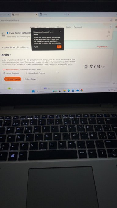 The image shows an open laptop computer screen displaying a webpage with information about the Outlier account and the Hedgehog project. The text on the screen indicates that the user can manage their accounts through the provided services, such as checking balances or reviewing transactions. Additionally, there is a message from someone named "AETHER" offering assistance for managing the accounts.