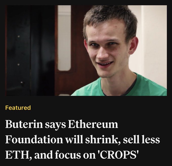The image features a man wearing a green shirt, smiling at the camera. Below him, there's text that reads "Peterin says Etherium Foundation will sell less eth, sell less ether, and focus on 'crops'". The caption also mentions that the Ethereum Foundation is selling less eth, which means they are reducing their supply of eth coins to maintain a certain price or value for them.

The image does not contain any other objects or people besides the man in the green shirt and the text above him.