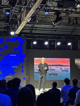 The image shows a man standing at a podium, giving a speech or presentation to an audience of people who are attentively listening. The setting appears to be indoors with a stage setup featuring speakers and lights, suggesting that this could be a conference or event taking place in a large room. The post on social media has the caption "Economic freedom looking GOOD here @coinbase". This implies that the speaker is discussing economic policies or ideas related to cryptocurrency, which may have caught the attention of the audience members present at the event.