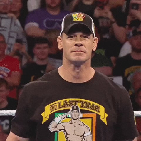 urn of gold and green, with a black banner reading "The Last Time" above it, is displayed on the ring at a wrestling event.