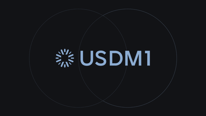 A dark logo with the text 'USDM1' in light blue, accompanied by a circular loading icon to the left, displayed against a black background with subtle overlapping circle outlines.