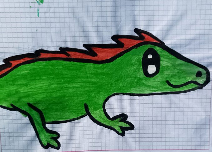A hand-drawn illustration of a green lizard or salamander with red spiky spines along its back, drawn on graph paper.
