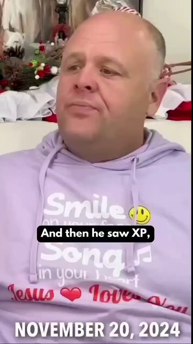 The image features a man wearing a purple hoodie with a smiley face design, sitting down and looking at the camera. The caption below the photo reads "He was shown an X & P. Is he speculating the middle letter omission? $XPR". This suggests that the man might be speculating about the missing letters in the middle of the phrase "X&P" or possibly discussing a recent event involving an X and a P.