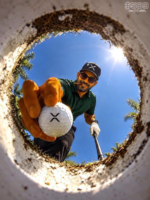 A man wearing a cap and sunglasses reaches into a golf hole to retrieve a ball with an 'X' logo, wearing an orange glove.