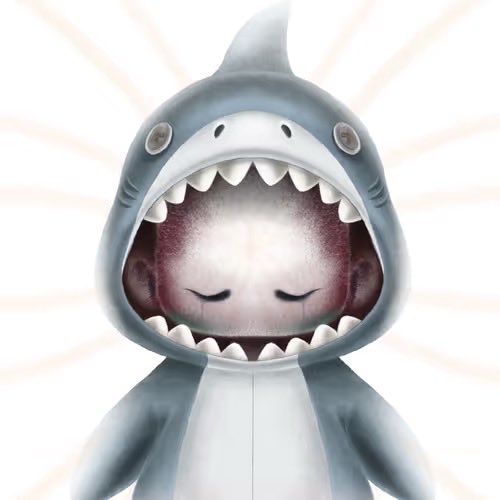 A cartoon shark character with its mouth wide open, revealing a small, peaceful face with closed eyes nestled inside the jaws. The whimsical artwork complements the post's lighthearted tone about diving back into the NFT space.