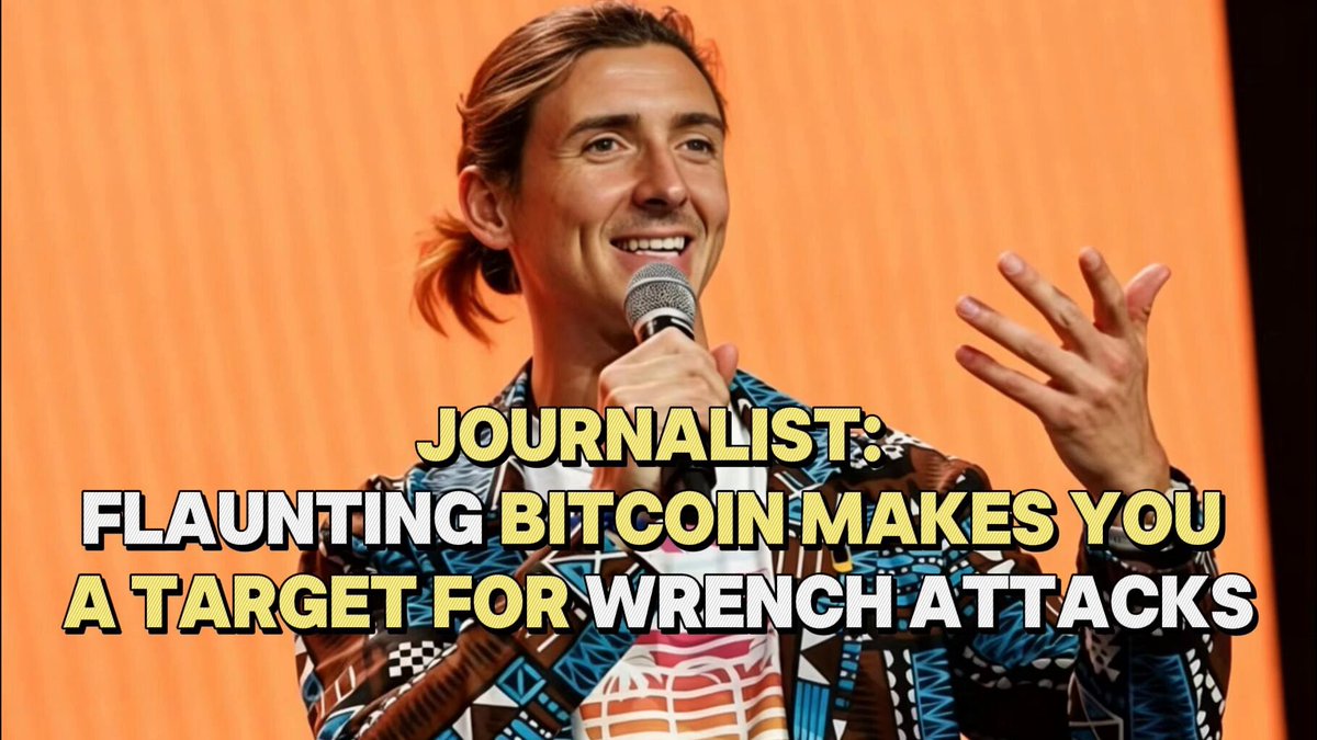 The image features a man wearing a brown and blue patterned shirt, standing next to a microphone with a microphone stand behind him. The background of the image is orange, which contrasts with the man's attire. The text "Journalist: Flaunting Bitcoin makes you a target for Wrench Attacks On May 22, 2026" suggests that the post is related to cryptocurrency and Bitcoin. The man appears to be giving advice or sharing information about Bitcoin in an attempt to educate others on its potential risks and how to avoid falling prey to crypto-related scams.