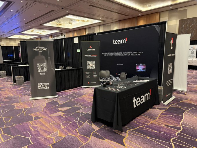 A trade show booth set up at a Las Vegas conference features a "team1" branded banner advertising their Avalanche blockchain builder network, alongside a "Cascade" welcome display with QR codes and "See You At The Summit" signage, corresponding to Team1's presence at RareEvo.