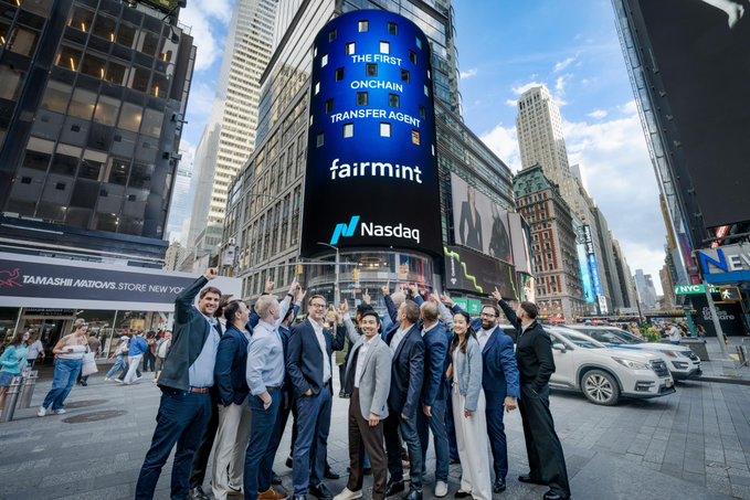 A group of formally dressed people pose cheering beneath the Nasdaq billboard in Times Square, which displays "THE FIRST ONCHAIN TRANSFER AGENT — fairmint — Nasdaq," celebrating Fairmint's milestone as the first onchain transfer agent built on Canton.