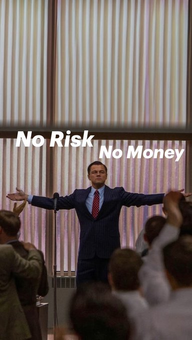 A man in a blue suit stands with arms outstretched before a crowd, with the text "No Risk No Money" overlaid on the image.