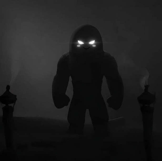 A dark, stylized image of a shadowy, muscular figure with glowing white, angry eyes standing between two faintly visible torches.