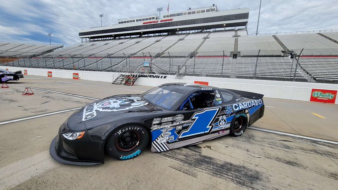 A black race car bearing the number '1' and 'CARDAVO' branding parked on a track at Nashville Speedway, with empty grandstands visible in the background.