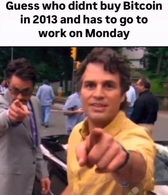 A classic meme featuring a man in a yellow shirt pointing at the camera with the caption 'Guess who didnt buy Bitcoin in 2013 and has to go to work on Monday'.