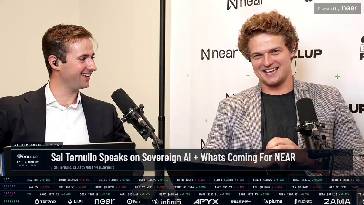 The image shows two men wearing suits, one of whom is speaking into a microphone while the other man is smiling at him. The background features a white wall with various logos and text, including "NEAR", "@sal_ternullo Timestamps", "Institutional Inbound Explained", "02:28 Bitcoin Negative Correlation", "04:35 NEAR Investment Thesis Evolution", "06:16 NEAR AI Stack", "08:29 Bear Case And Risks", and "09:56 Venice Integration".