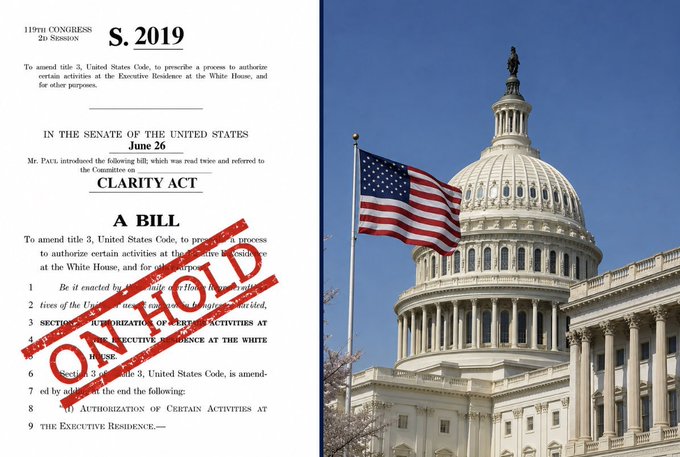 A document titled "S. 2019 / A BILL" marked "ON HOLD" in red stamp, displayed alongside the U.S. Capitol building and American flag, visually symbolizes the stalled CLARITY Act legislation awaiting a Senate vote.