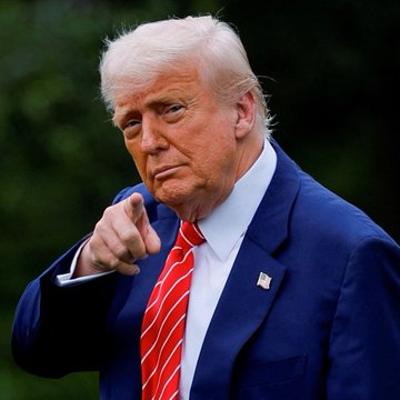 Former U.S. President Donald Trump, wearing a dark suit with a red striped tie, points directly at the camera with a stern expression, visually reinforcing his bold statement to TIME about using growth and inflation to reduce America's $40 trillion debt burden—comments that have reignited concerns over currency debasement and bolstered Bitcoin's appeal as a hedge.