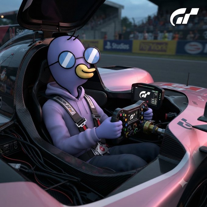 A purple cartoon character wearing round sunglasses sits in the driver's seat of a pink race car, gripping a steering wheel, with the 'GT' (Gran Turismo) logo in the corner.
