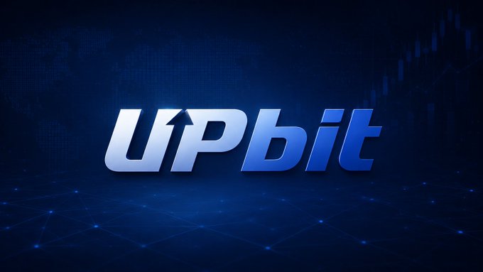 The image displays the Upbit logo in stylized blue lettering against a dark background with faint world map and network graphics. The logo confirms Upbit, a cryptocurrency exchange platform, as an active company, relating to the post's surprise that Upbit is still operating.