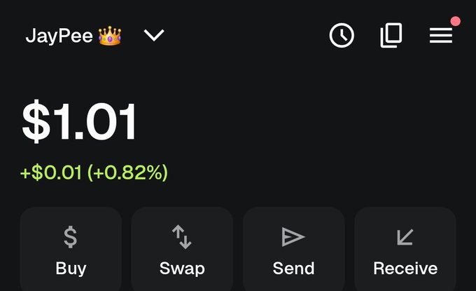 A crypto wallet dashboard for user "JayPee 👑" shows a balance of $1.01 (+$0.01, +0.82%), with options to Buy, Swap, Send, or Receive. The image humorously illustrates the post by showing a meager crypto balance in stark contrast to what is likely a much larger local currency (naira) account.