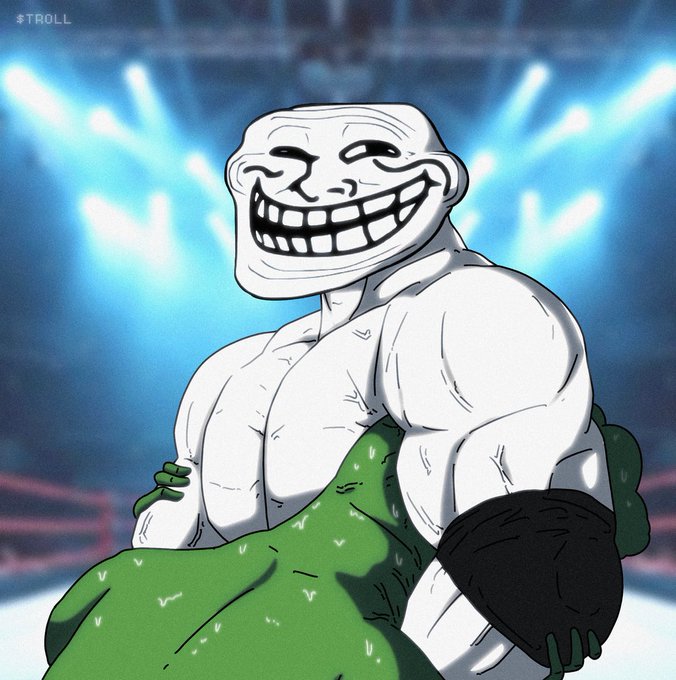A muscular "Trollface" character with an exaggerated grin stands victorious in a brightly lit wrestling arena, clutching a wrestling belt and a green opponent in his arms. The "#TROLL" hashtag in the corner reinforces the post's message that the troll always comes out on top.