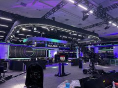 A futuristic poker arena branded "SOL POKER" glows with neon-lit screens and advanced gaming equipment under dramatic stage lighting, with the "solana" ticker displayed on a central signage. The image visually reinforces the post's claim of a revolutionary, next-level poker experience powered by Solana.