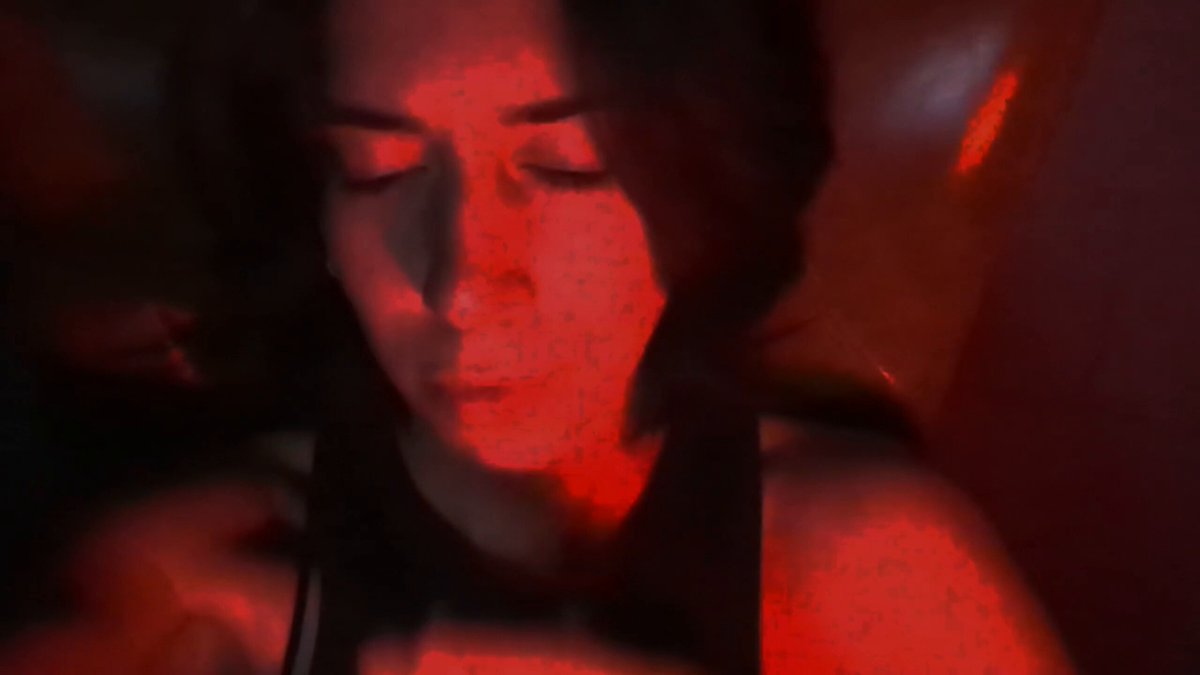The image shows a close-up of a person's face, with their eyes closed and mouth slightly open. The background appears to be red or orange, possibly due to a light source or a warm color tone. The photo has been edited to give it a surreal appearance, as if the person is floating in space. The caption below the image reads "I'm not a smoker I just watch my predictions on @jup_predict 0 - 0". This suggests that the person might be making predictions about something or someone else's future actions while they are in this surreal and distorted setting.
