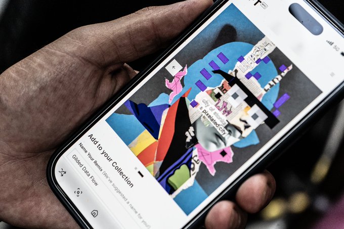 A hand holds a smartphone displaying an NFT artwork titled "City of Stonks - A pixelated city," with the interface prompting "Add to Your Collection." The screen shows a pop-up reading "City of Stonks pixelated city," reflecting the digital art's connection to NFT NYC and the creator's excitement about its growing ecosystem.