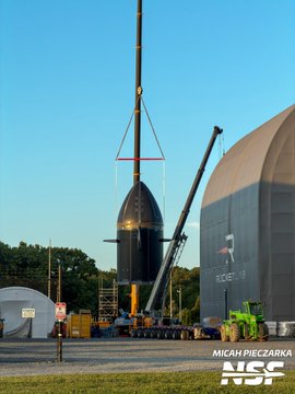 A Rocket Lab Neutron rocket's upper stage is being lifted by a crane near the company's facility, as captured by photographer Michał Pieczarka for NSF, signaling a transition into the testing phase of development for the $RKLB spacecraft.