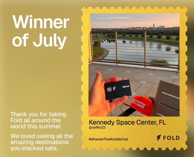 "Winner of July" announcement graphic from Fold featuring a photo of a hand holding a Fold card at Kennedy Space Center, FL, with the caption "Thank you for taking Fold all around the world this summer."