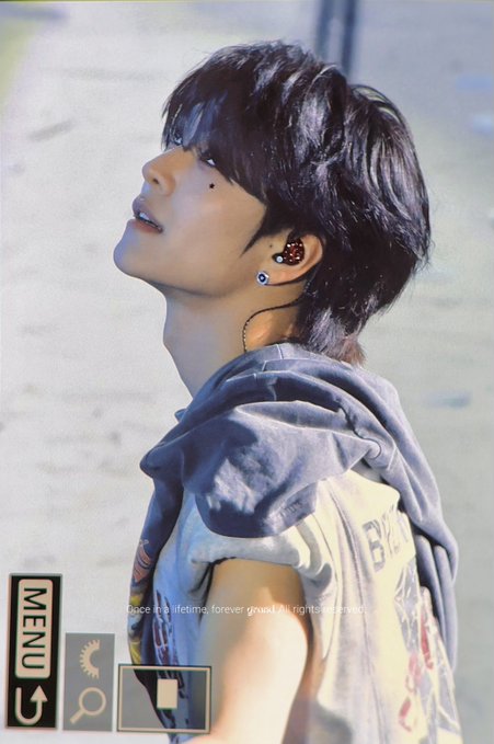 A young man with dark hair looks upward while wearing in-ear monitors and a denim hoodie over a graphic t-shirt, with on-screen text reading "Once in a lifetime, forever graisle, all rights reserved" and "MENU" — likely a fan-edit screencap from the 260628 ALPHADRIVE ONE stage performance, captured to wish member Xin Long happiness during the show as expressed in the hashtags #XINLONG #鑫龍 #씬롱.