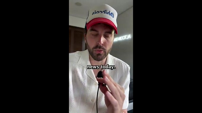 A man wearing a white and red 'Dickies' cap and a white knit shirt, speaking into a microphone with the subtitle 'news today.' visible.