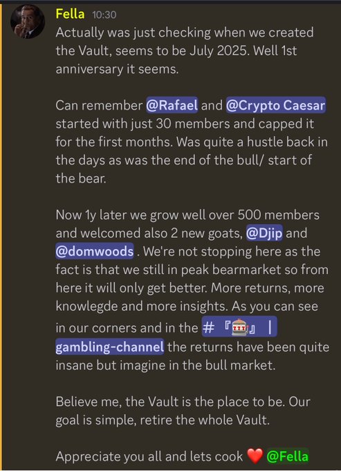 A Discord message from user "Fella" at 10:30 celebrates the 1-year anniversary of "the Vault," noting it started in July 2025 with just 30 members alongside @Rafael and @Crypto Caesar, and has since grown to over 500 members with new goals @Djp and @domwoods. The post aligns with the caption by highlighting the Vault's growth, bullish outlook, and goal to "retire the whole Vault" and "create many millionaires" despite current bear market conditions.