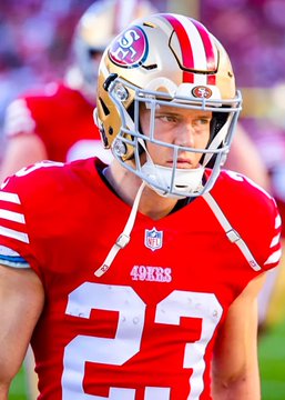 A 49ers player wearing jersey number 23 and a gold helmet stands on the field, representing the team that received a $42,000 bet to win their game against the Rams on Polymarket, with the wager set to pay out $121,024.00.