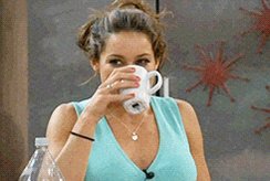 urn of water on a table, with a woman in a blue tank top drinking from it and a red star decoration above her head.