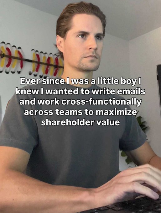 A man types at a keyboard with overlaid text reading 'Ever since I was a little boy I knew I wanted to write emails and work cross-functionally across teams to maximize shareholder value'.