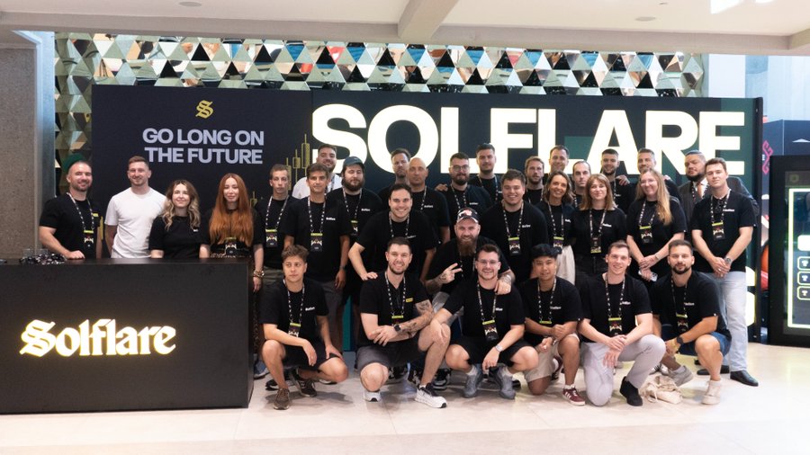 Team members pose together at the Solflare booth during Day 2 of Solana Summit Serbia, with the company's "Go Long on the Future" branding displayed prominently on the backdrop.