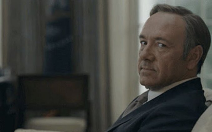 A man in a dark suit sits in a dimly lit room, turning his head to give a skeptical, side-eyed glance toward the camera.

The image captures a look of quiet doubt and suspicion, visually echoing the post's question by suggesting the speaker is unconvinced that the hype around Robinhood Chain is here to stay.