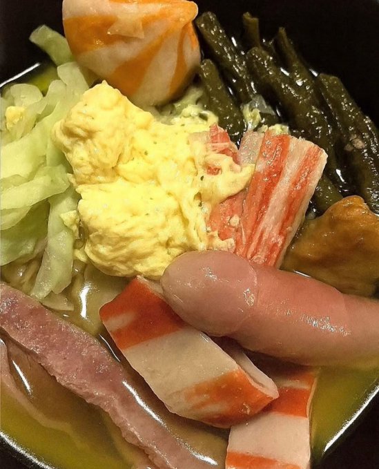 A close-up of a hot pot-style dish featuring scrambled eggs, green beans, cabbage, imitation crab sticks, sausages, and pink fish cake strips in a light broth. The "Smash or Pass?" caption fits the casual, grocery-store-sushi-meets-buffet aesthetic of the meal, which might require some courage to commit to.