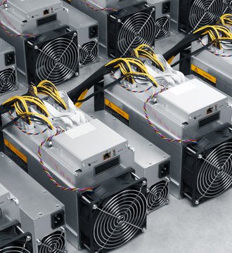 Rows of industrial bitcoin mining rigs with cooling fans and tangled yellow power cables are arranged on a warehouse floor, visually illustrating the hardware used to monetize stranded energy for large-scale crypto mining operations.