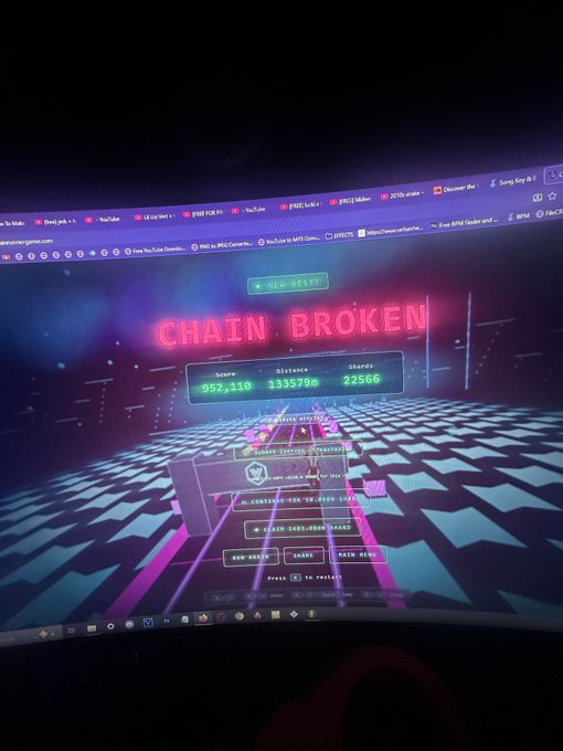 The image shows a computer screen displaying a game with the title "Chain Broken" at the top, along with a scoreboard showing that the player has scored 1,857,735 points. The game appears to be a racing or driving game where players can race cars on a track and compete against each other for the highest score.