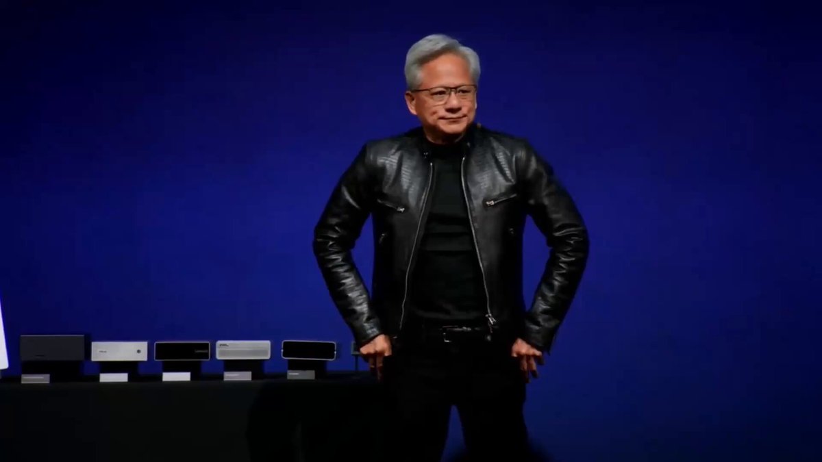 The image features a man standing next to a table with several electronic devices, including multiple computer mice and keyboards. He appears to be wearing a black leather jacket and glasses, giving him a professional appearance. The background of the image is blue, which contrasts with his attire and adds depth to the scene. The caption "hyperliquid i need an emergency listing" suggests that there might be some sort of technical issue or problem related to these electronic devices, possibly requiring immediate attention from the person in the picture.