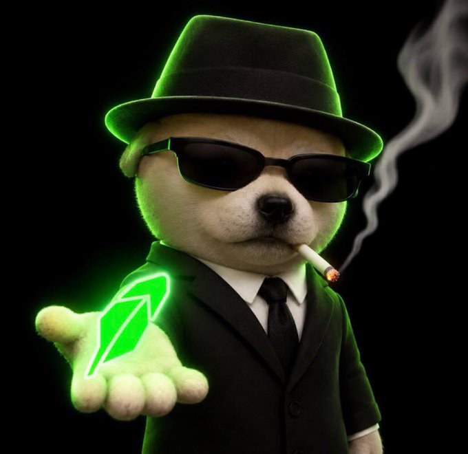A digitally rendered white puppy dressed in a black suit, fedora, and sunglasses, holding a glowing green gem and smoking a cigarette against a black background.