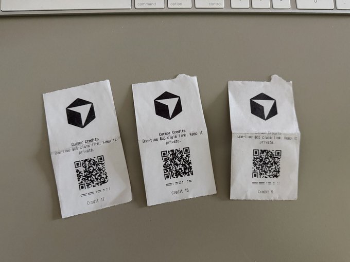 Three paper 'Cursor Credits' receipts with QR codes laid out on a desk, labeled 'Credit 17', 'Credit 16', and 'Credit 8'.
